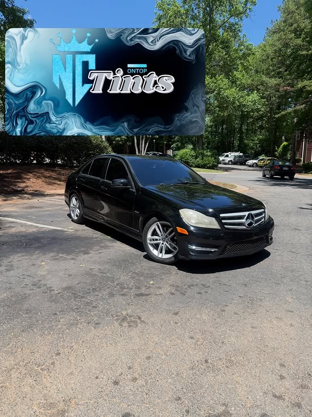 Black Mercedes sedan with dark window tint