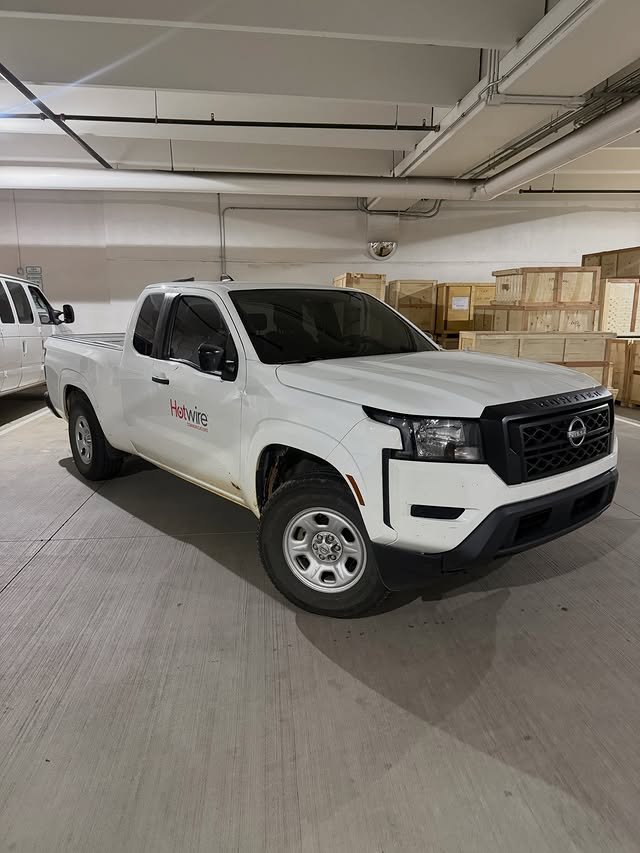 White Nissan Frontier with dark side window tint